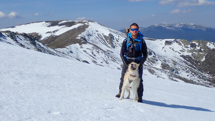 MOUNTAIN ON SNOW MOUNTAIN TOP WITH DOG