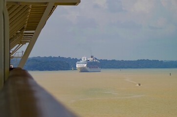 Modern Princess cruiseship or cruise ship liner sails Chagres River during transit of Panama Canal