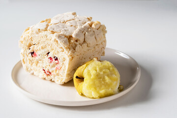 Meringue with a baked apple on a plate.