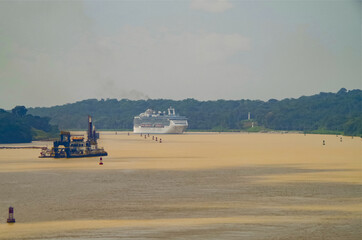 Modern Princess cruiseship or cruise ship liner sails Chagres River during transit of Panama Canal