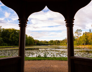 A view from the arbour beside the ornamental Cow Pond, with blue sky and clouds, in the 35 acre...