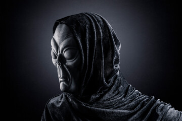 Fototapeta na wymiar Portrait of a scary humanoid alien in the dark