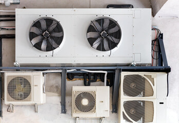 The compressor unit and air conditioners are installed on the wall of the old building.
