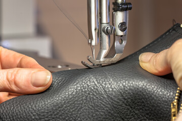 Sewing machine operated by hands in workshop