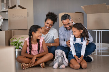 Ethnic family enjoy new house after moving day