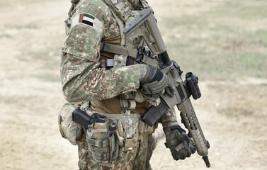Soldier with assault rifle and flag of _ on military uniform. Collage.
