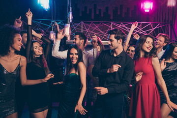 Photo portrait of cheerful excited people dancing together at luxury party in pink and blue neon...