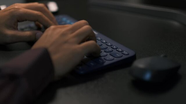 Close up shot of an young business woman's hands busy working on laptop or computer keyboard for send emails and surf on a web browser late hour and working late at night in the office