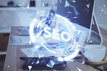 Multi exposure of table with computer and seo drawing hologram. Search optimization concept.