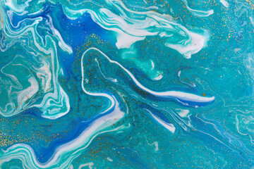 Gold and light blue mixed inks spilled background. Turquoise texture.