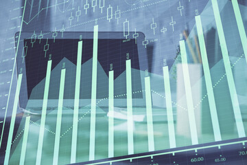 Forex graph hologram on table with computer background. Multi exposure. Concept of financial markets.