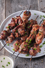 Food photo. Turkey skewers on caps in white plate.