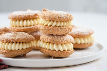 Delicious hazelnut shortbread sandwiches filled with vanila cream. Christmas recipe.