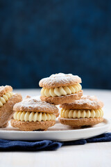 Delicious hazelnut shortbread sandwiches filled with vanila cream. Christmas recipe.