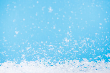 Artificial snow on blurred background, new year concept