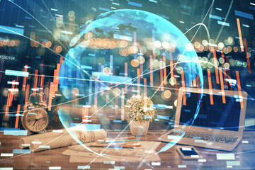 Double exposure of graph and financial info and work space with computer background. Concept of international online trading.