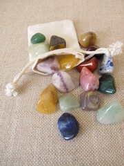 Colorful tumbled gemstones in a small bag