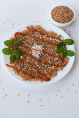 Broken wheat dosa or Roti with tomato sauce , Kerala breakfast , tea time snack with broken wheat and grated coconut. Sweet food or spicy.