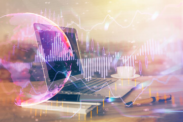 Financial graph colorful drawing and table with computer on background. Multi exposure. Concept of international markets.