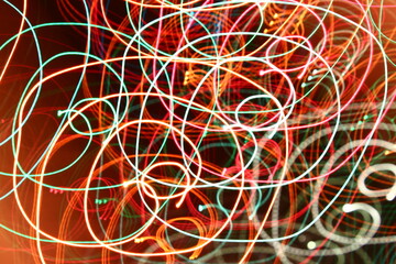 abstract color swirl garland lights. Blurred glowing on dark background