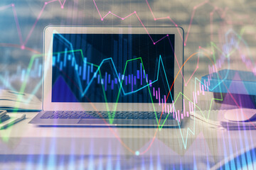 Financial graph colorful drawing and table with computer on background. Double exposure. Concept of international markets.