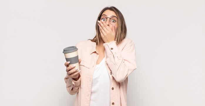 young blonde woman covering mouth with hands with a shocked, surprised expression, keeping a secret or saying oops