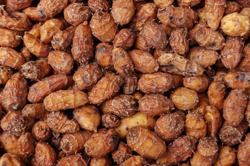 Close up of pile of raw tigernuts or chufa as background, top view.