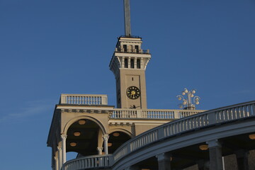 Clock tower.A view with lanterns and a white balcony with Baroque balusters in front of a blue...