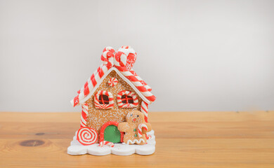 Gingerbread house toy on light gray background