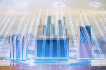 Double exposure of chart and financial info and work space with computer background. Concept of...