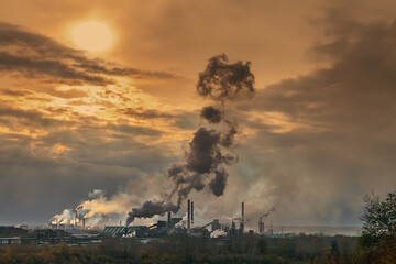  pipes of a large plant smoke in the sky