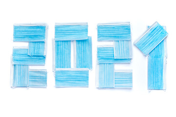 Numbers of the year 2021 made with blue face masks on a white background. Covid and Coronavirus concept in the new year.