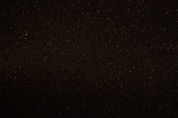 Black shiny glitter background, glowing blurred pattern for Christmas and New Year cards