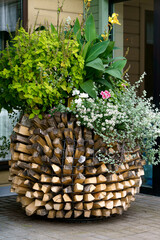 A flower bed with flowers stylized as a pine cone at the expense of firewood.