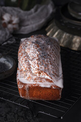Freshly baked poppy seed pie. Cake with fondant. Baking with poppy seeds on a dark background