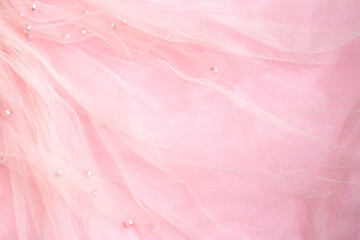 Beautiful bright pink tulle with shiny beads background. Draped background of pink powdery fabric,...