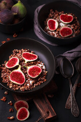 Breakfast with granola and figs. Black plates with a fresh and healthy Breakfast. Healthy food with fruit

