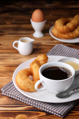 Fresh homemade Chinese donut with black coffee on vintage wooden table. Freshness breakfast with boiled egg for healthy and nutrition food with top copy space for your advertising content.
