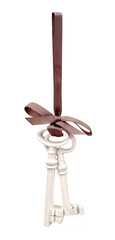Silk ribbon with a bow and keys isolated on white background for creating graphic concepts
