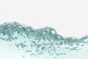 Close up blue water splash with air bubbles. Fresh and clean surface aqua flowing in wave and clean water on white background isolated. Advertising image with free space for your work