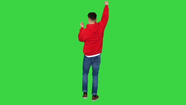 Casual man dancing in a red hoody on a Green Screen, Chroma Key.