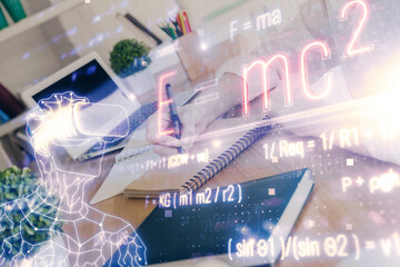 Science formula hologram over woman's hands taking notes background. Concept of study. Double exposure