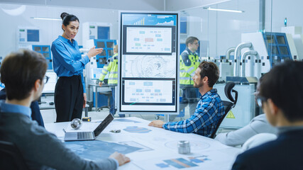 On a Meeting: Confident Female Engineer Talks to a Group of Specialists, Managers, Uses Interactive...