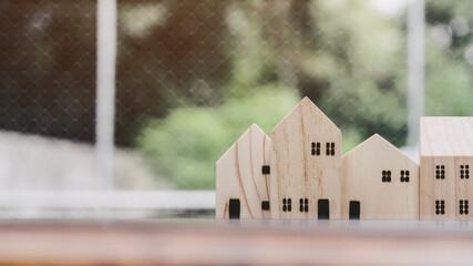 House wooden toy model on brown desk table, close up.