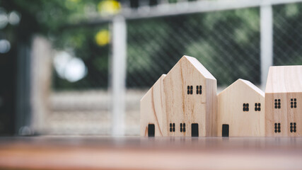 House wooden toy model on brown desk table, close up.