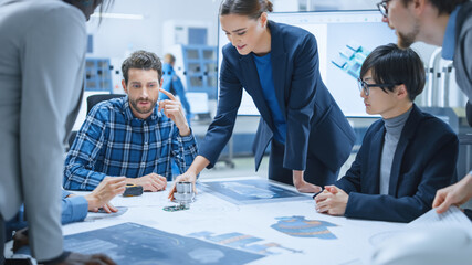 Busy Diverse Team of Engineers and Specialists Gather Around Conference Table, They Discuss Project...