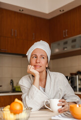 Portrait of a beautiful thoughtful woman enjoying cup of coffee at home