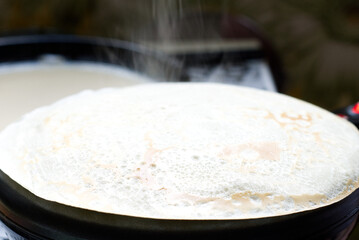 big round pancake on electric frying pan