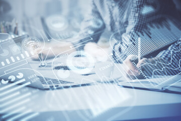 Technology theme hologram with man working on computer on background. High tech concept. Double exposure.