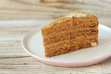 a piece of honey cake on a plate on a wooden table